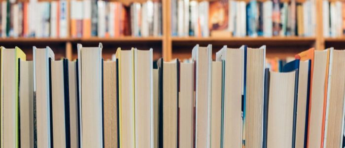 Rows Of Books On A Shelf In Library